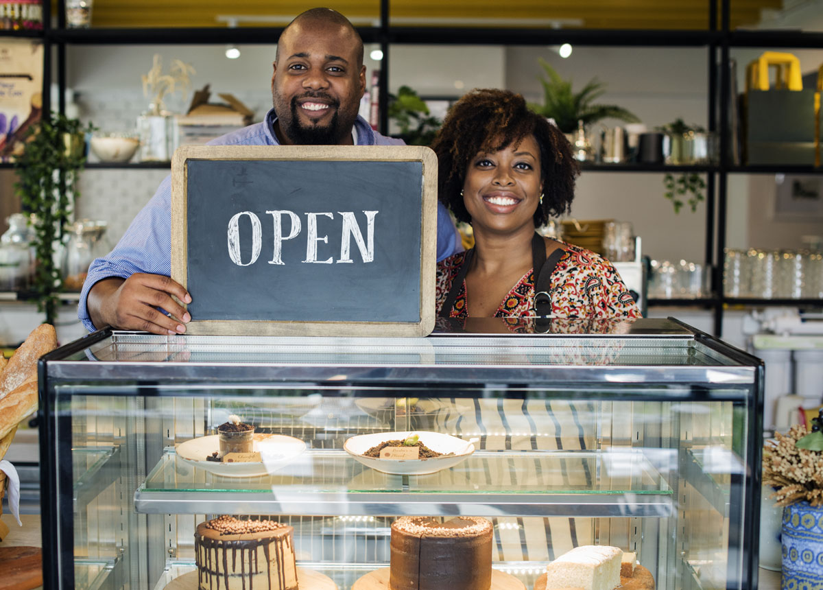 cake-cafe-owners-with-open-sign